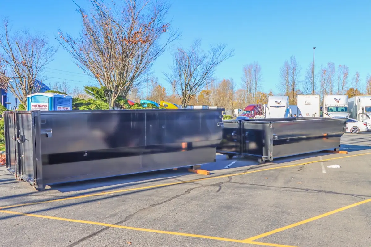 Professional dumpster rental service with roll-off container on residential driveway in Milpitas